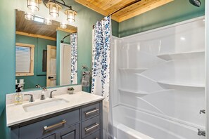 Combined shower/bathtub, hair dryer, towels, toilet paper