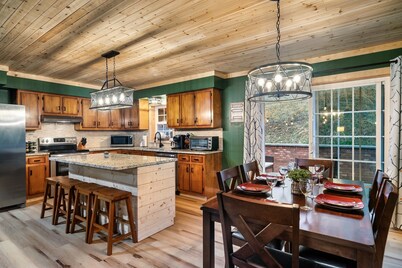 The Peaceful cabin in the woods with a Hot tub, fire table and game room!!