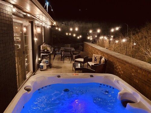 The Peaceful cabin in the woods with a Hot tub, firepit, and game room!!