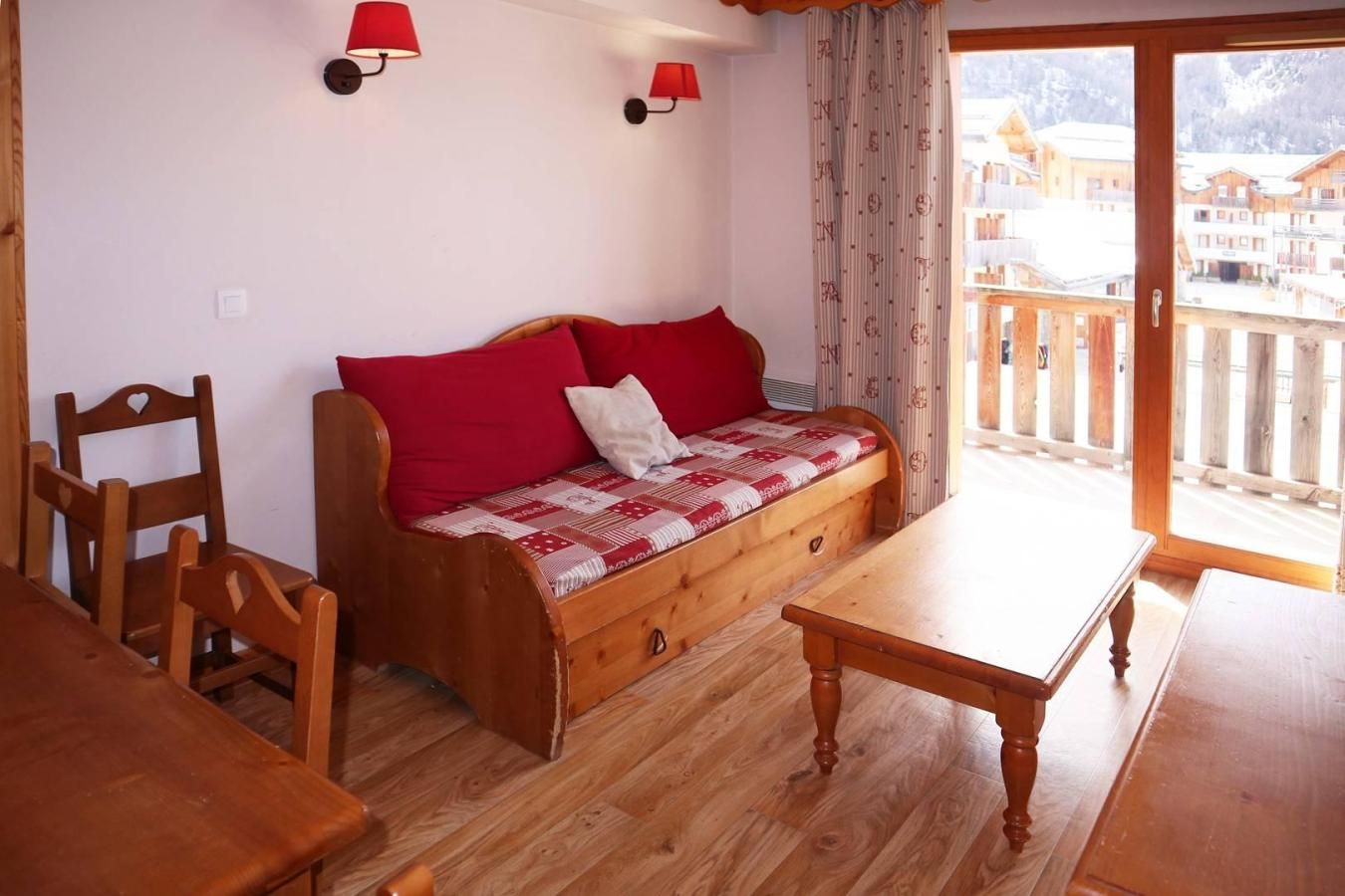 Una habitación acogedora con un sofá y una mesa de madera, además de sillas.