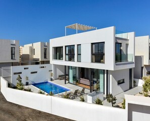 A modern two-story house with a swimming pool, large windows, and a flat roof. - Protaras Almaria Villa 16 (Protaras)