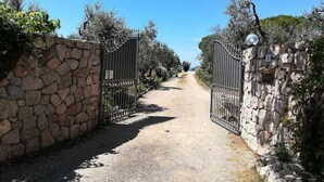 A pathway leading to a gated area with stone walls and metal gates. - Villa Saha wonderful villa (Itri)