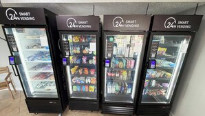 Four 24-hour vending machines with a variety of snacks, drinks, and other items.