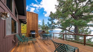 A wooden deck with outdoor furniture, a grill, and a view of the lake. - Lakefront Retreat in Tahoe City- large home in Dollar Point (Tahoe City)