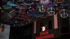 A bar with a sign reading "Barby Karaoke Night Club" and a ceiling adorned with various umbrellas and disco balls. - Barby Butik Otel (Kemer)