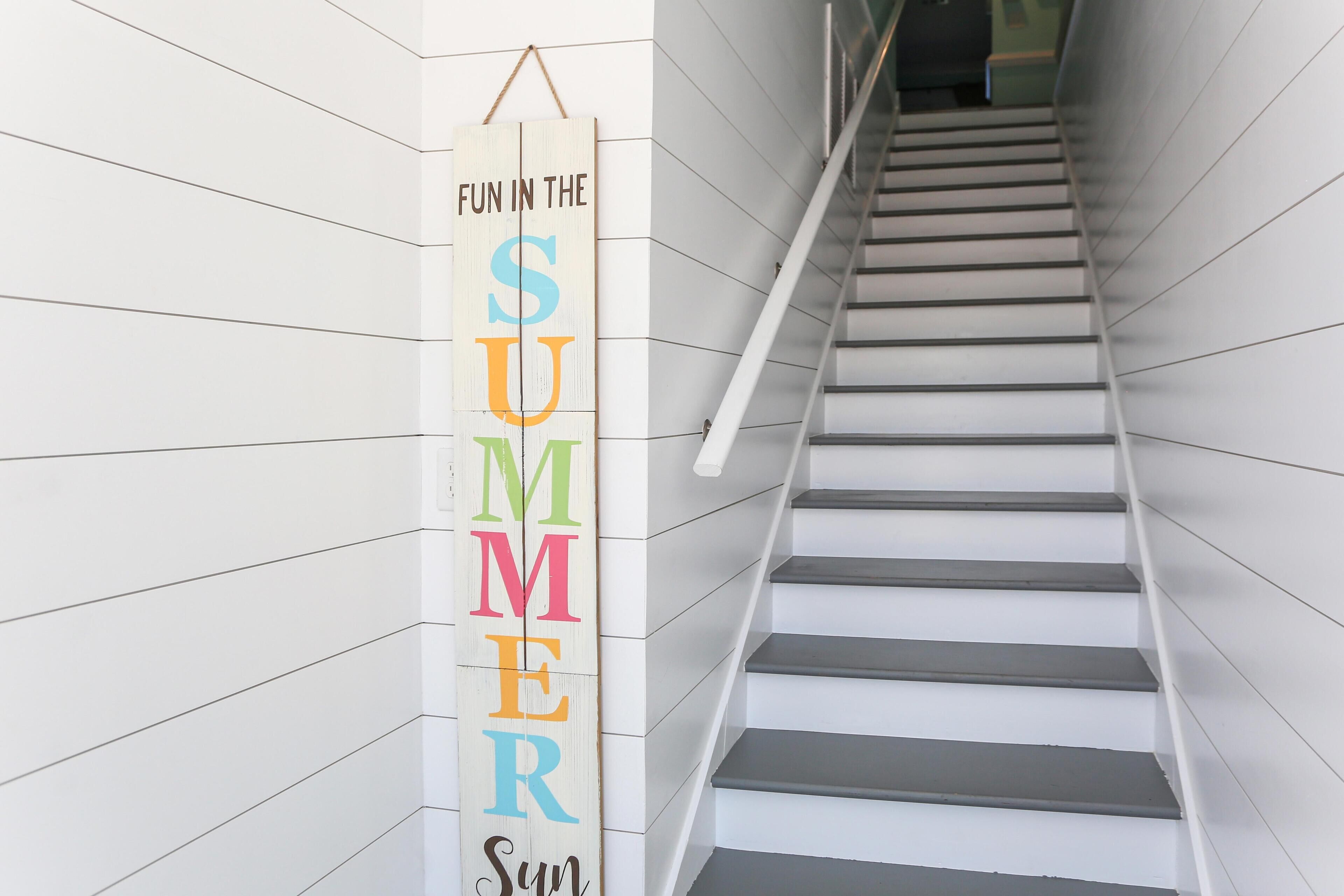 A staircase with a vertical sign that reads "FUN IN THE SUMMER."