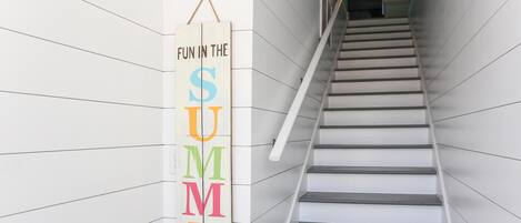 A staircase with a vertical sign that reads "FUN IN THE SUMMER."