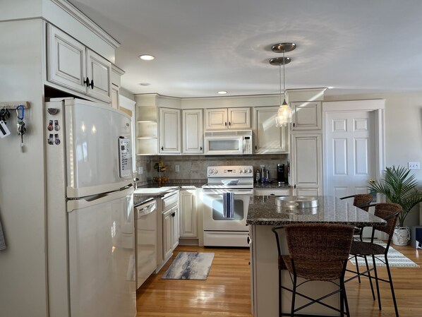 Enjoy cooking in this well-equipped kitchen with a large island and sink.