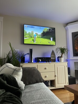 Relax in this inviting living room with a flat-screen TV, entertainment unit, and comfortable sofa.