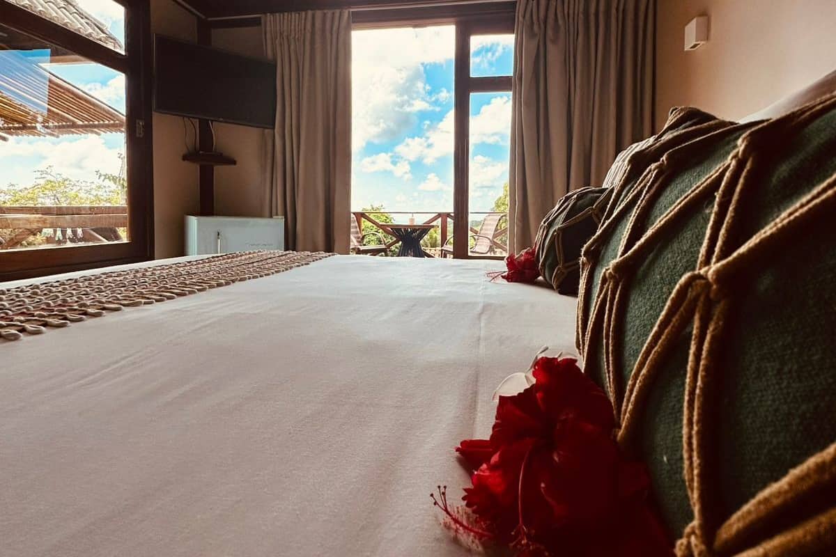 Ein Zimmer mit Bett, Fernseher und Blick ins Freie.