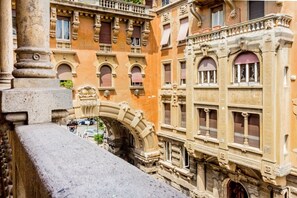 A historic building with ornate architectural details, including arched windows and decorative stonework. - Historic house in the Palazzo degli Ambasciatori Coppedè neighborhood (Roma)