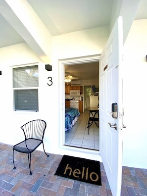 Enter a welcoming home with a kitchen, dining area, and cozy bed.