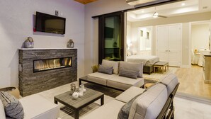 A modern living room with a fireplace, sofa, and coffee table. - Costal Chic Vila w/Private Pool/Spa --5 min from the Beach! (Naples)