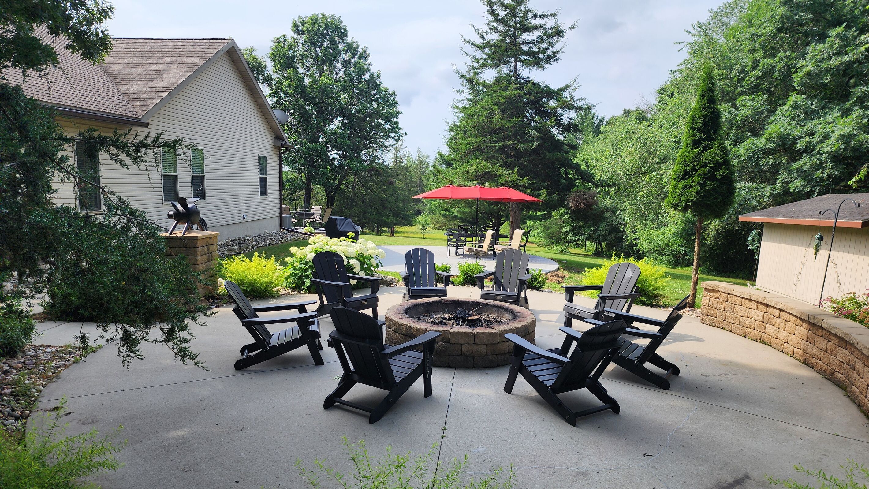 A patio with outdoor furniture and a fire pit.