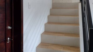 A staircase with wooden steps and a white wall. - Family Studio with all the comforts, centrally located. (Jalapa)