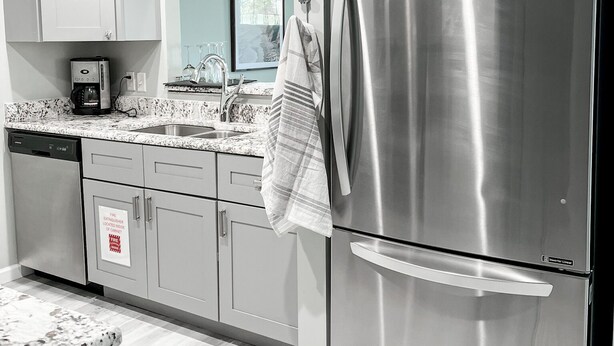 A modern kitchen with stainless steel appliances, a dishwasher, and a granite countertop.