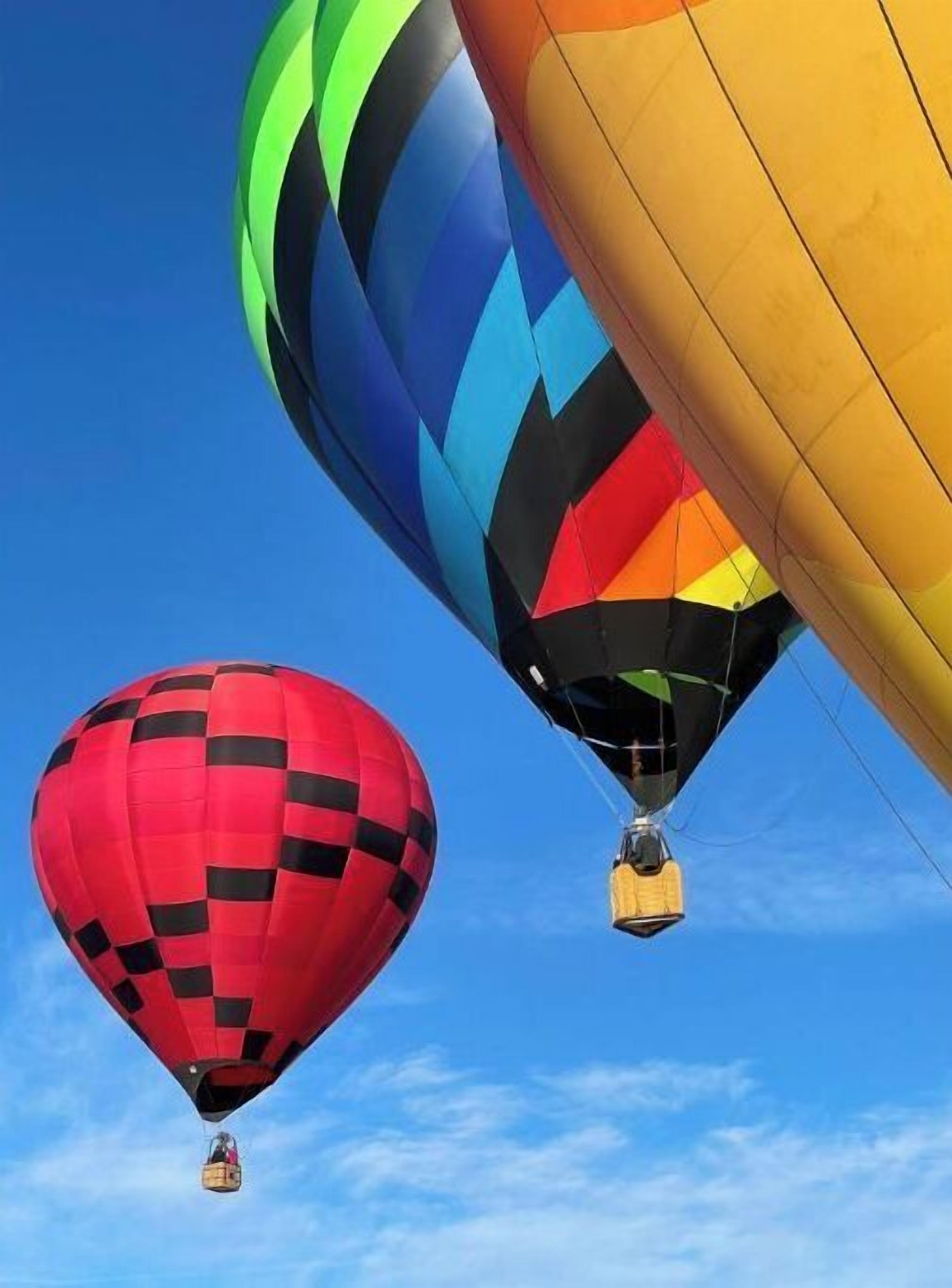 Three hot air balloons in the sky.