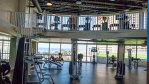 A multi-level gym with various exercise equipment, large windows, and a view of the outdoors. - Aqua Penthouse 2br/2ba with Infinite Ocean Views (Panama City Beach)