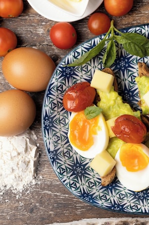 A plate with eggs, tomatoes, cheese, and bread.
