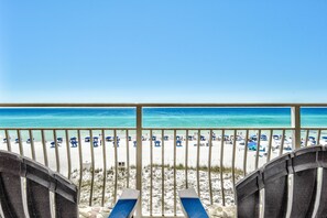 A beach view from a balcony with lounge chairs and umbrellas. - Crystal Sands 312B. Completely Renovated Stunner, Free Beach Service, Pool. (Destin)