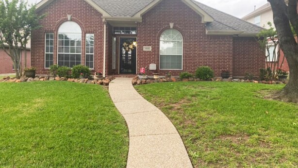 A two-story brick house with a front entrance, a visible mailbox, and a paved driveway leading to the door. - West Plano Stay – Private Retreat Near AT&T Stadium for FIFA 2026 (Plano)