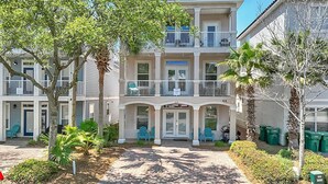 A multi-story building with balconies, a paved walkway, and outdoor seating. - ☛5 Minutes from the Beach★ Pool/ Hot Tub★ Stocked☚ (Destin)