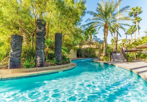 Surrounded by lush greenery, this serene pool area offers a tranquil escape.