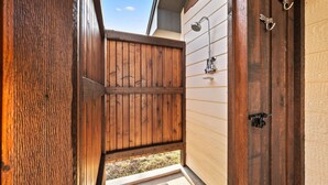 A wooden door with a metal handle and a small metal hook. - Texas Hill Country Escape in Hye, TX (Hye)