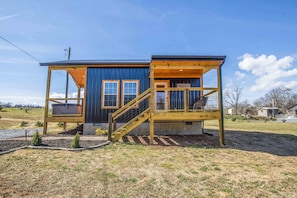 Guests can enjoy a covered entrance and a deck.