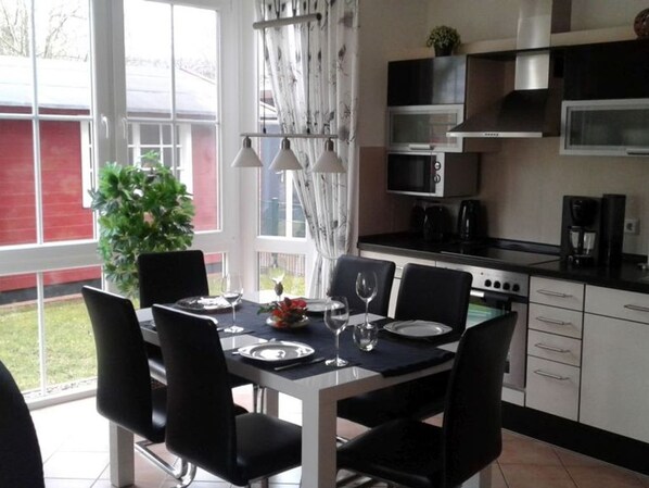 A modern kitchen with a dining area.