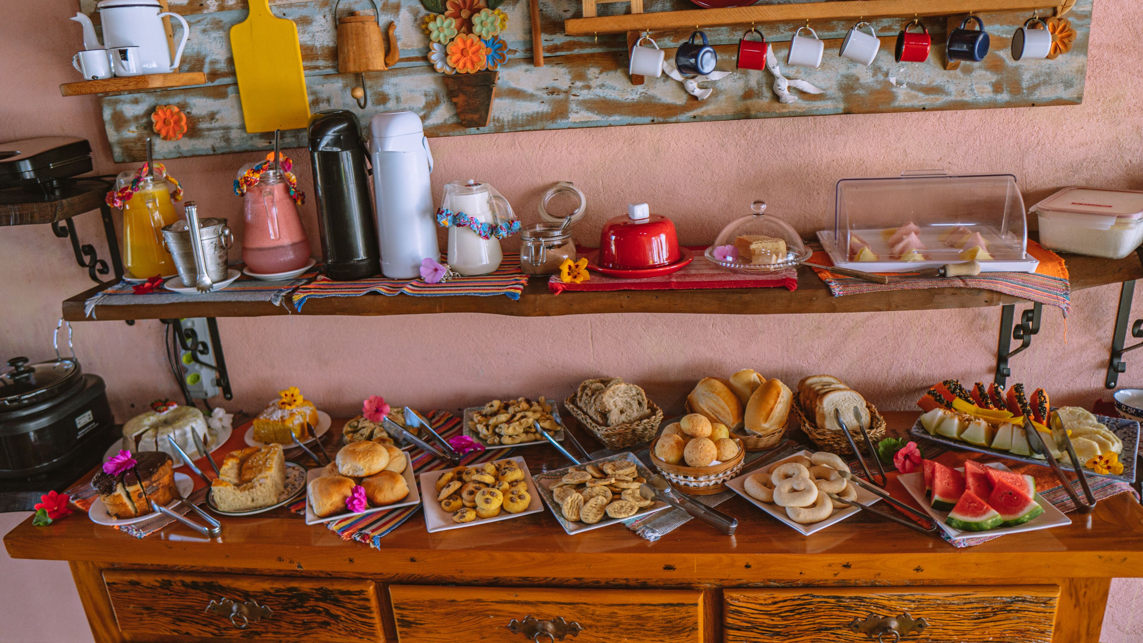 A buffet setup with various food items and kitchenware.