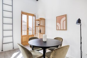 Cozy retreat with a round table, bookshelf, and artwork, perfect for reading and relaxation.