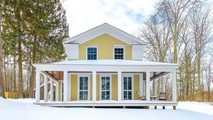 A two-story house with a covered porch and a snow-covered roof. - Charming Sharon Dwelling w/ Deck & Fire Pit! (Sharon)
