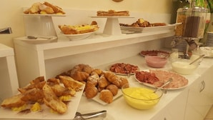 A buffet with various food items including pastries, meats, and condiments. - Hotel Gioiosa (Cesenatico)
