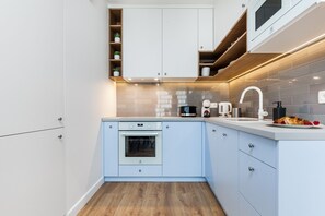 Exclusive Apartment | Private kitchen | Full-size fridge, microwave, oven, stovetop