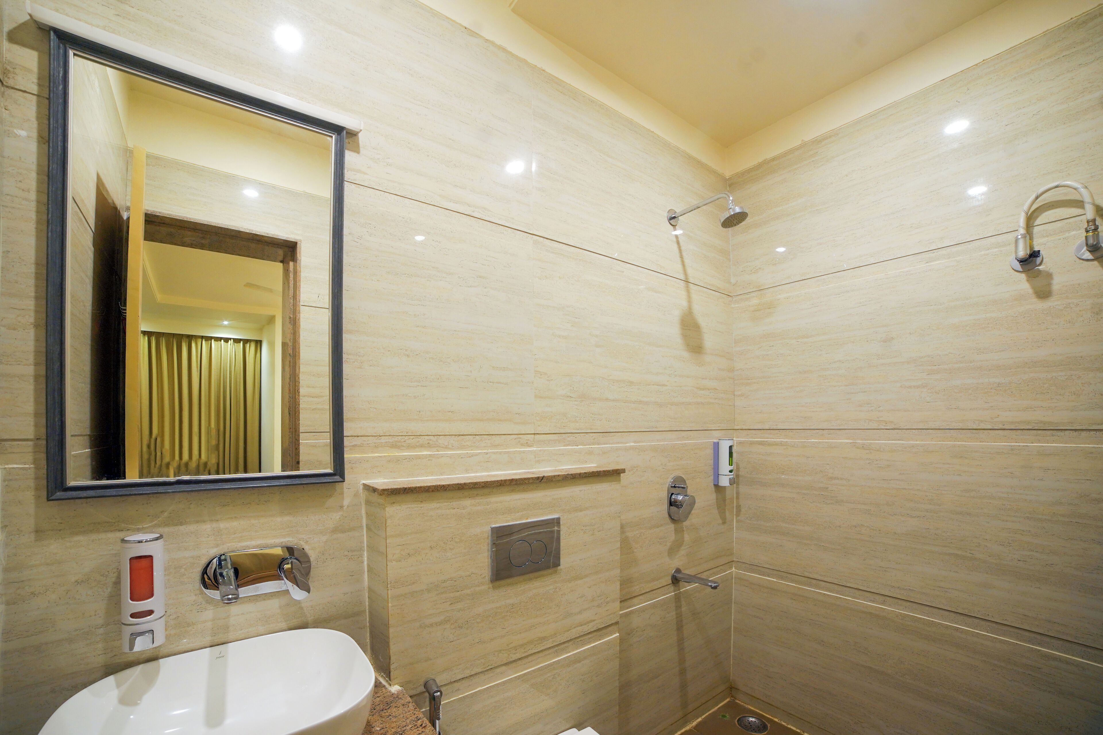 A bathroom with a sink, mirror, shower, and towel rack.