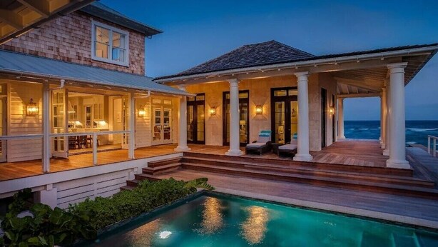 A beachfront property with a pool, a covered patio, and a view of the ocean. - Sea Oats, Hope Town - Luxury Beachfront Home (Hope Town)