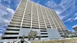 A high-rise building with multiple balconies and a modern architectural design. - Beach-Front Condo, 2 Reserved Parking Spaces!, Large Balcony, Fabulous Views! (Panama City Beach)