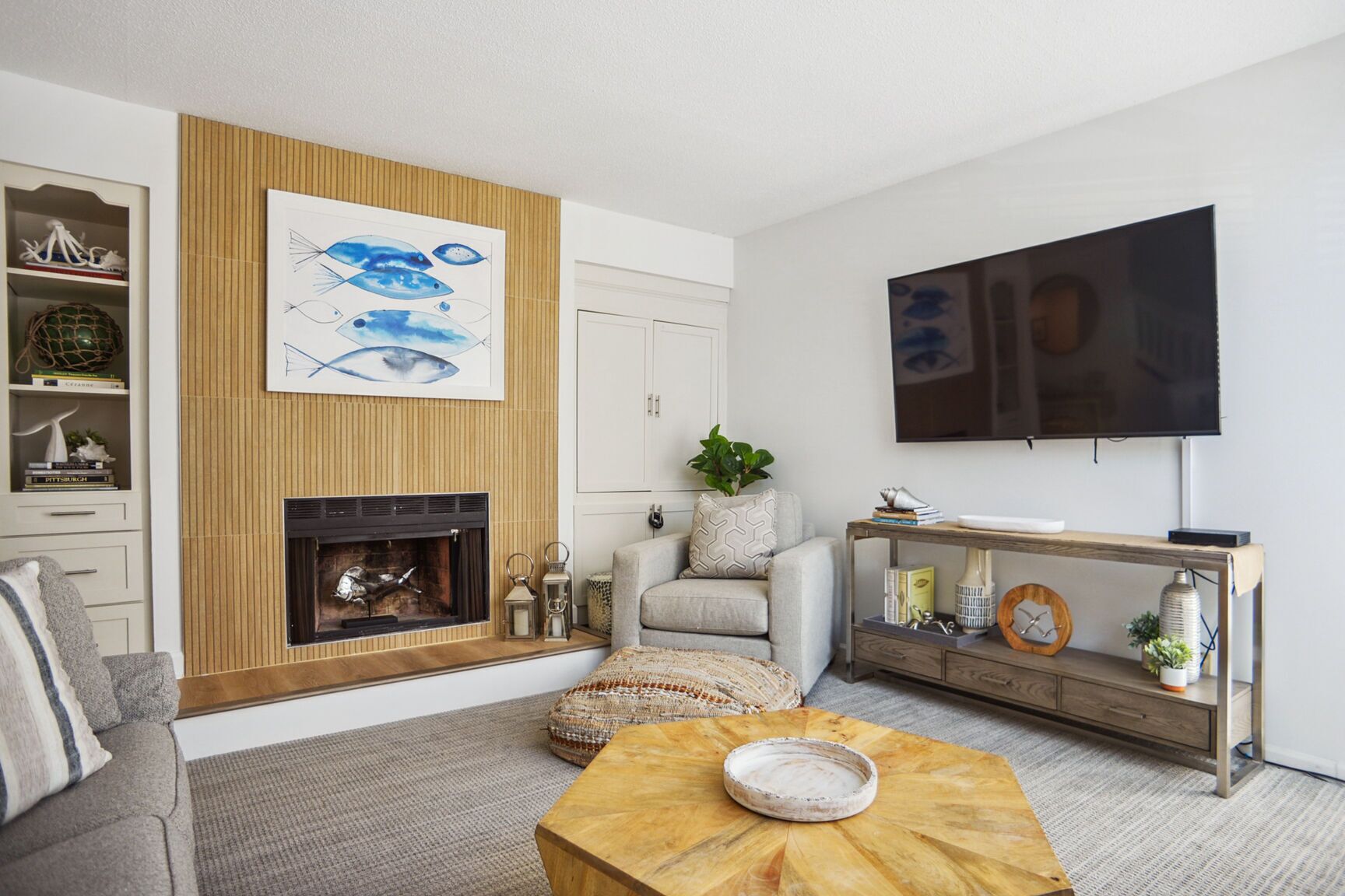 Un salon moderne doté d’une cheminée, d’un téléviseur à écran plat et d’un mur décoratif en bois.