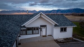 A single-story house with a gabled roof, a front door, and a small porch area. - Mountain View Home w/Hot Tub - Close to Downtown! (Bozeman)