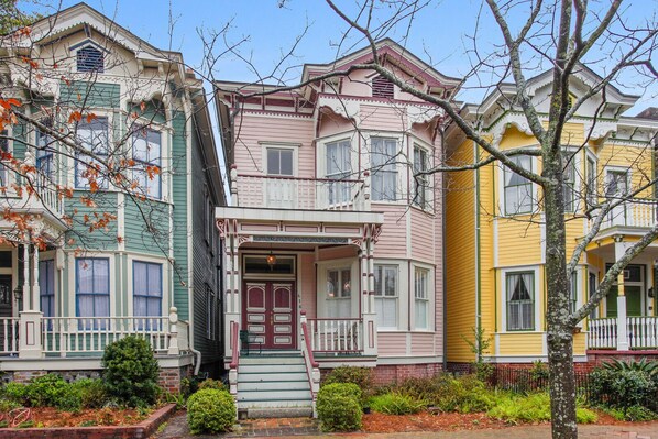 A row of colorful Victorian-style houses with distinct architectural features.