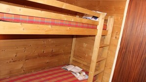 A bunk bed with a plaid bedspread and a book on the lower bunk. - 200m from ski slopes, 4th floor, tv, 31m², Val Thorens (Val Thorens)