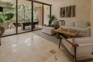 Deluxe Apartment | Living area | 50-inch Smart TV with digital channels, TV, books - Lumina at LOSANTOS Tulum (Tulum)