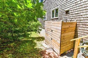 A wooden house with a wooden gate, a window, and a hose on the right side. - Minutes to Oceanside Beaches! (Eastham)
