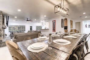 A dining area with a rustic wooden table set for six, surrounded by chairs. - Scottsdalestays Shangri-La 10BR-5BA on 1/2 Acre-Resort Pool w/Cabana-Pickleball (Phoenix)