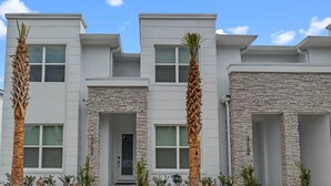 A modern two-story building with a stone facade, large windows, and a central entrance. - Jose's Tikki Room near Disney (Clermont)