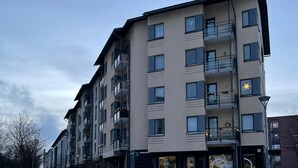 A multi-story building with balconies, a bike shop, and a snow-covered ground. - Specious roofapartment apartment, tropical velvet (Helsinki)