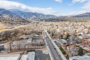 A town with a main road, buildings, and mountains in the background.