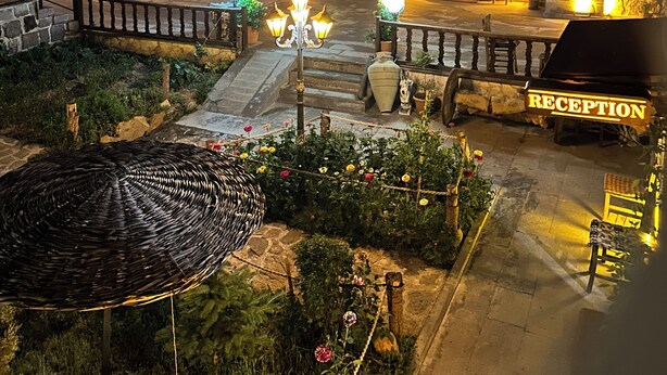 A historic hotel with stone architecture, arched doorways, and a reception area.
