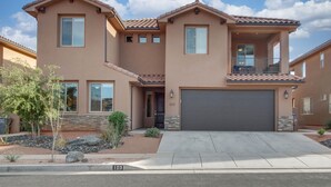 A two-story house with a garage, stone accents, and a landscaped front yard. - Paradise Village Resort 103: Resort View, Private Hot Tub, Short Walking distance to Resort (Santa Clara)